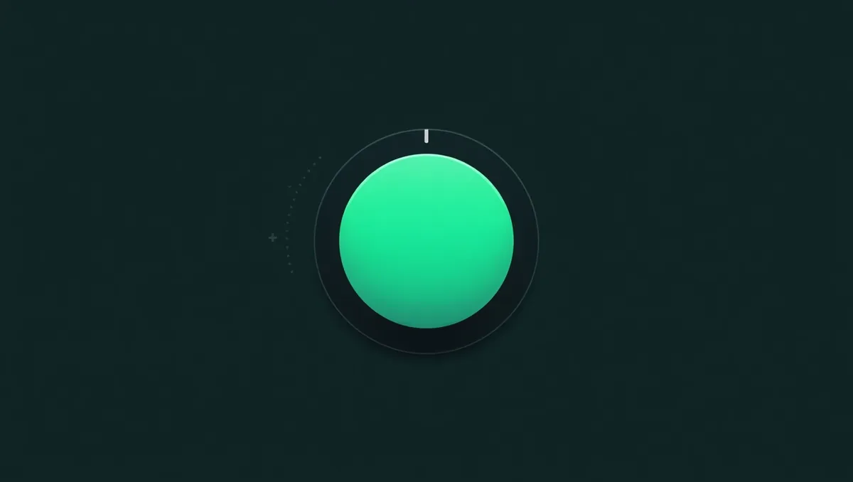 A large glowing green button on a dark control panel with a small dial set to a mark